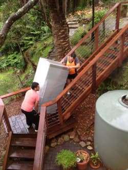 Workers climbing stairs with furniture